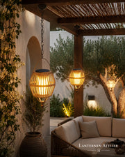 Hängende Solar-Laternen mit warmem LED-Licht in einer Outdoor Lounge unter einer Pergola