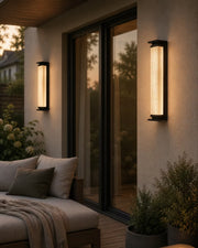Solar-Wandlaterne in Schwarz mit warmem Licht an einer Terrassenwand bei Abendlicht