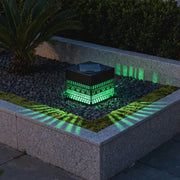 Solar-Würfellaterne mit farbigem Licht neben Beet und Gartenweg